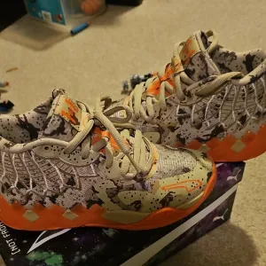 Puma Melo Kids Camouflage Sneakers with Orange Accents